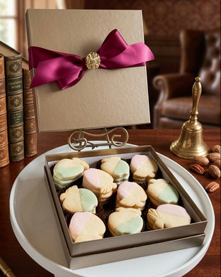 Box of shortbread with a decorative bow on a wooden table.